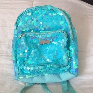 A Turquoise, sequence justice mini backpack.